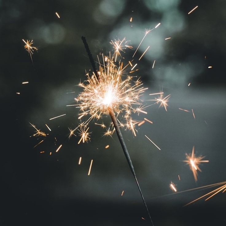 Firework launching bright sparks into the night sky