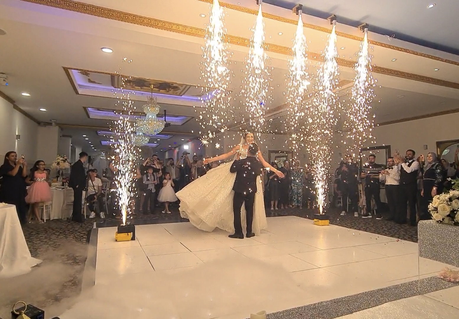 IMG_6698 Bride and groom’s first dance with indoor sparklers and cheering guests around the dance floor.