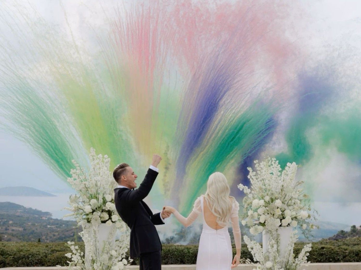 paste Bride and groom celebrate with vibrant coloured smoke mine on their wedding day